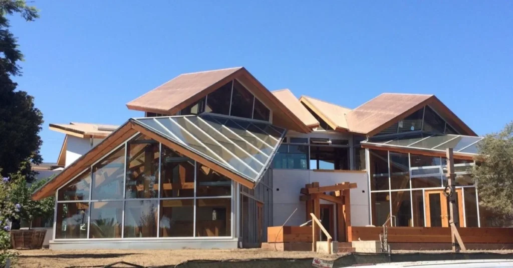 Frank Gehry House featuring angular wooden rooflines, extensive glass walls, and the distinctive deconstructivist style that revolutionized residential architecture