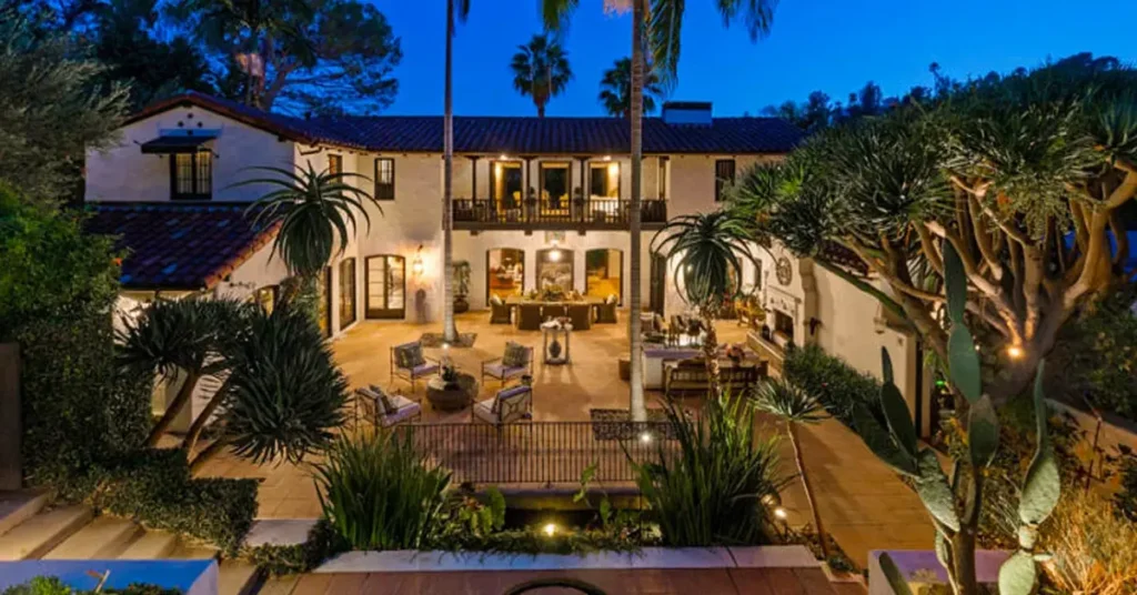 Robert Pattinson House featured image: lavish Spanish-style villa with courtyard, palm trees, and elegant lighting.