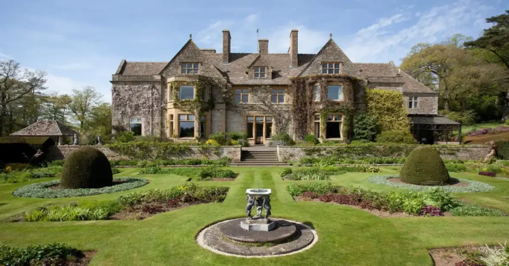 Victoria Beckham House luxury estate with manicured gardens and ivy-covered manor showcasing Posh Spice's multi-million dollar property portfolio strategy